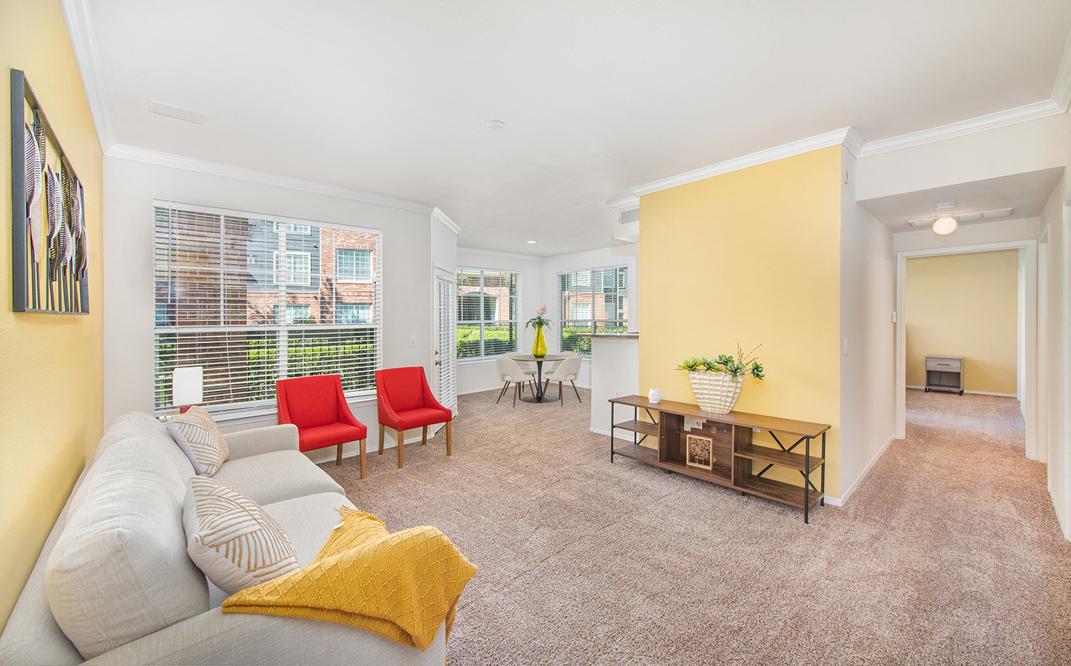 a living room with a couch and a table with chairs