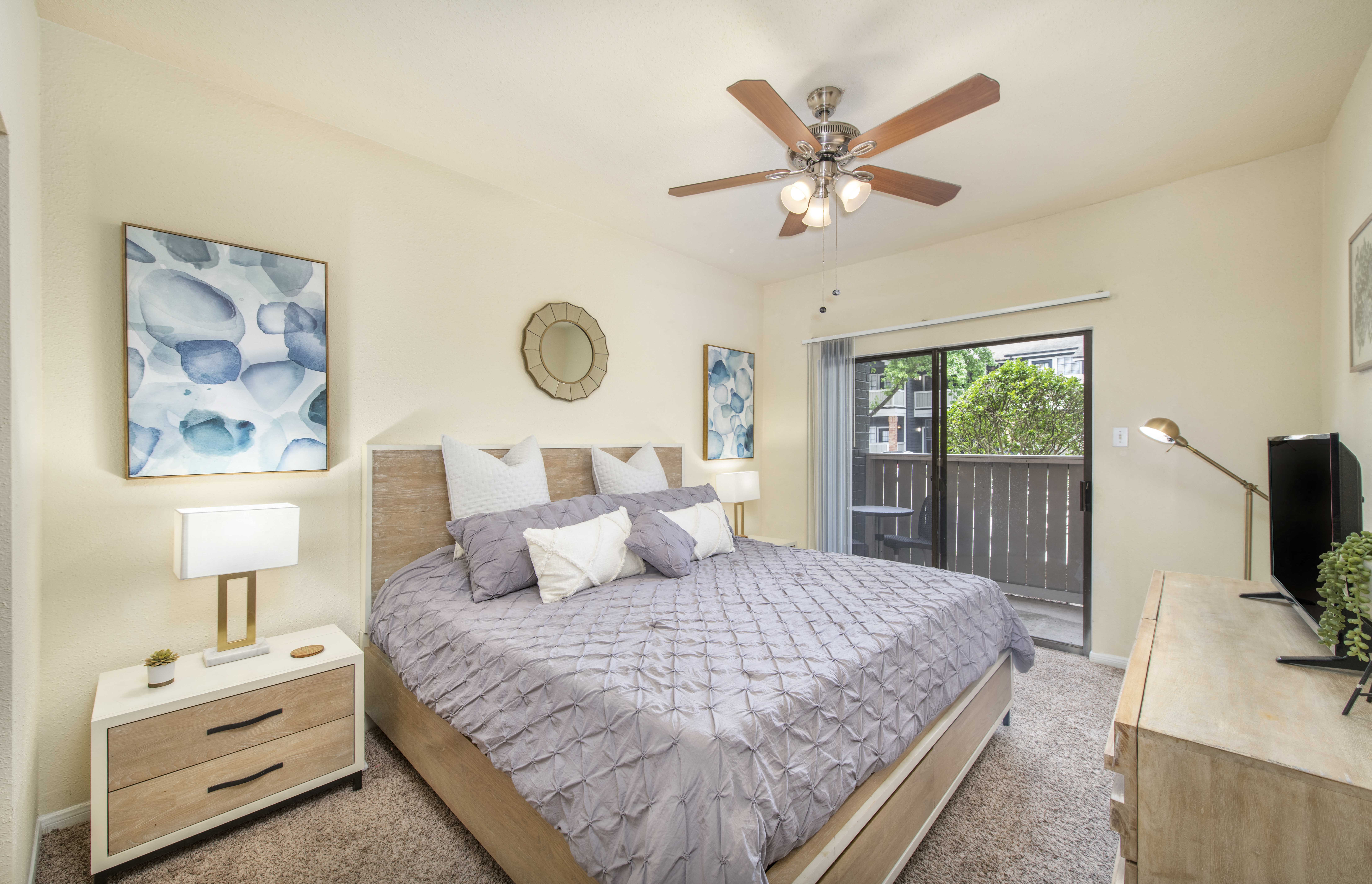 a bedroom with a bed and a ceiling fan