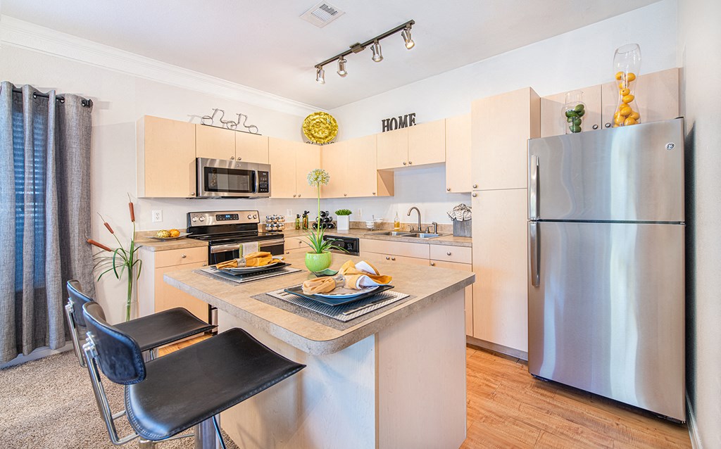 a kitchen with stainless steel appliances and a counter top