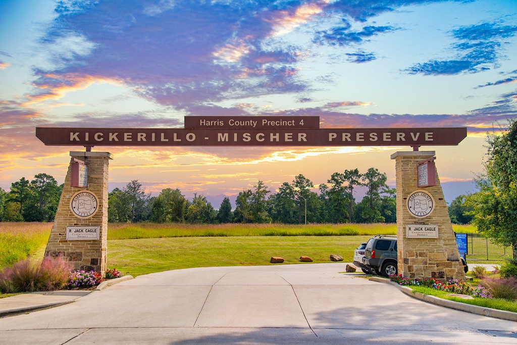a sign preserve with a sunset in the background