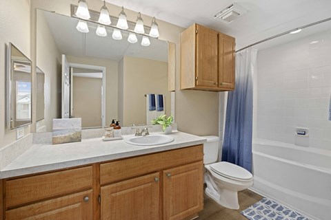 A bathroom with a white sink and a white toilet.