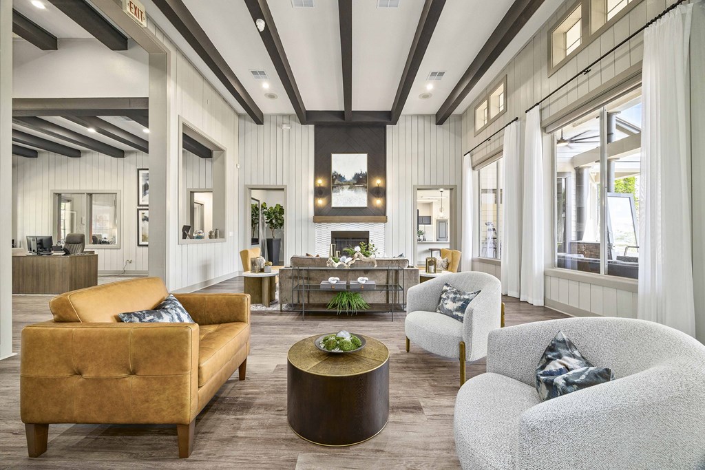 A living room with a yellow sofa, two grey armchairs, and a coffee table.