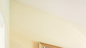 a bedroom with a large bed and a ceiling fan