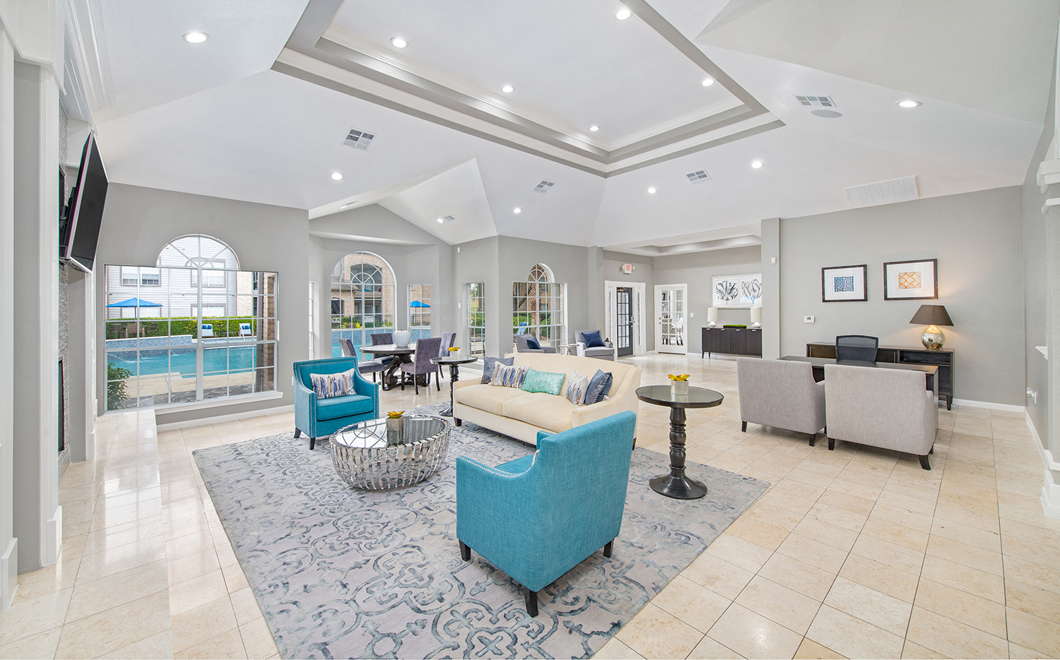 a living room with couches and chairs and a tv