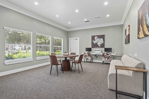 a living room with a couch and a table with chairs