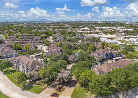 an aerial view of a neighborhood with houses and trees