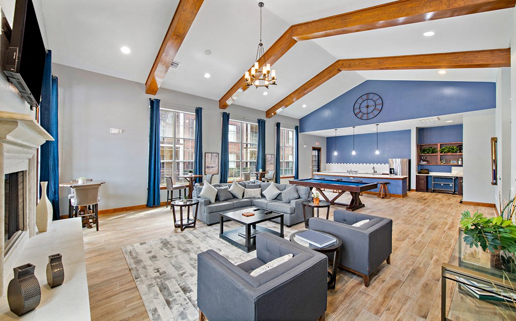 a spacious living room with couches and a pool table