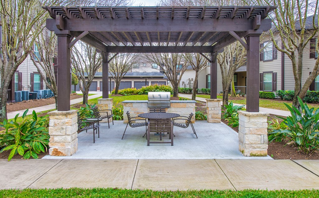a patio with a table and chairs under a pavilion