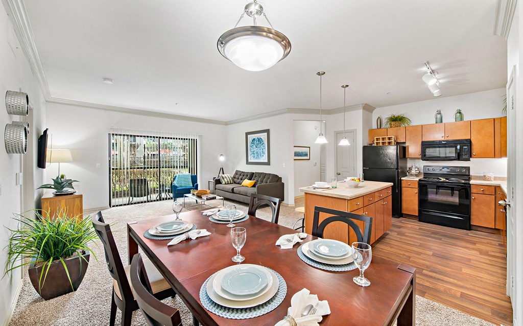 a living room with a dining room table and a kitchen