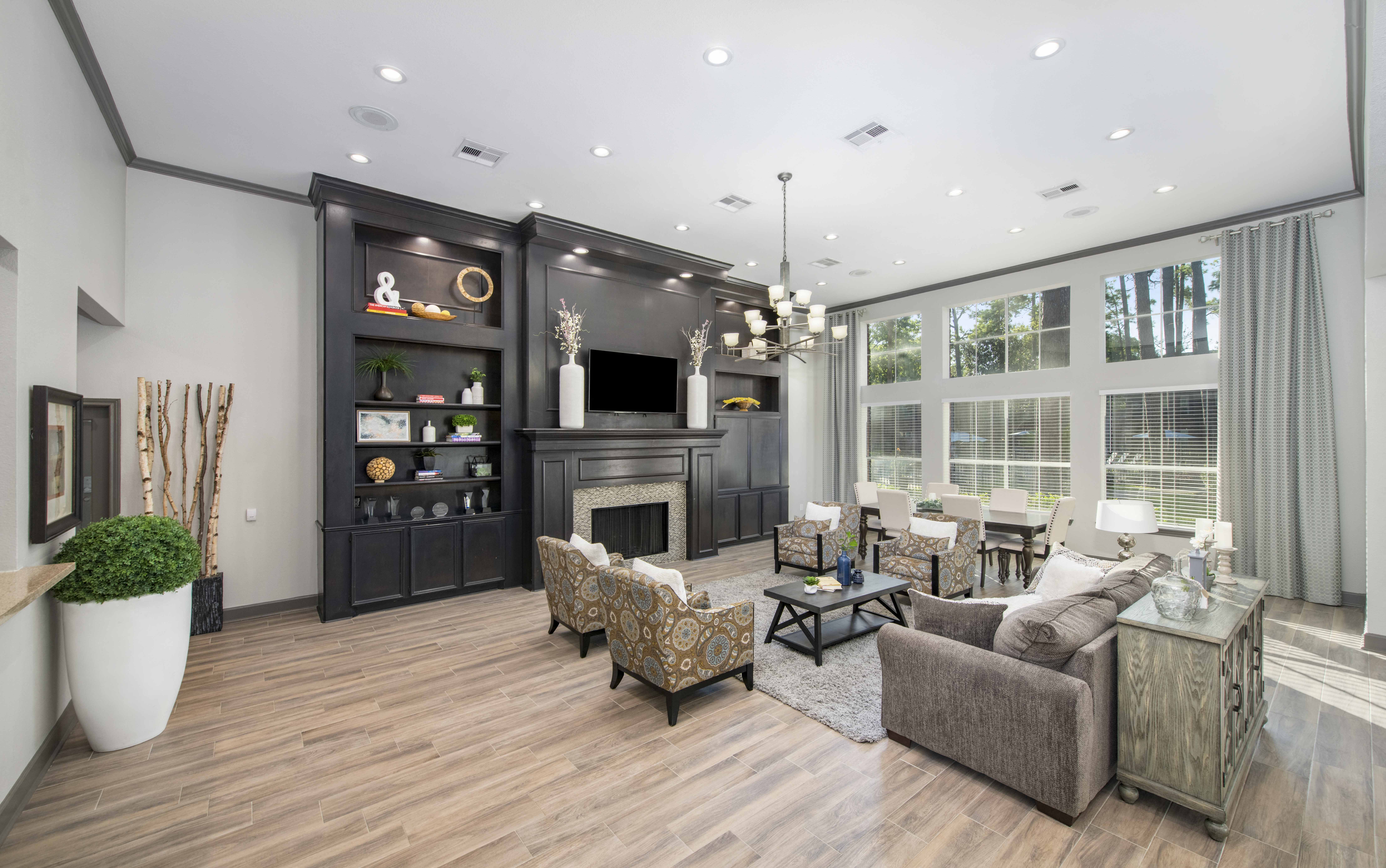 a living room with a fireplace and a table and chairs