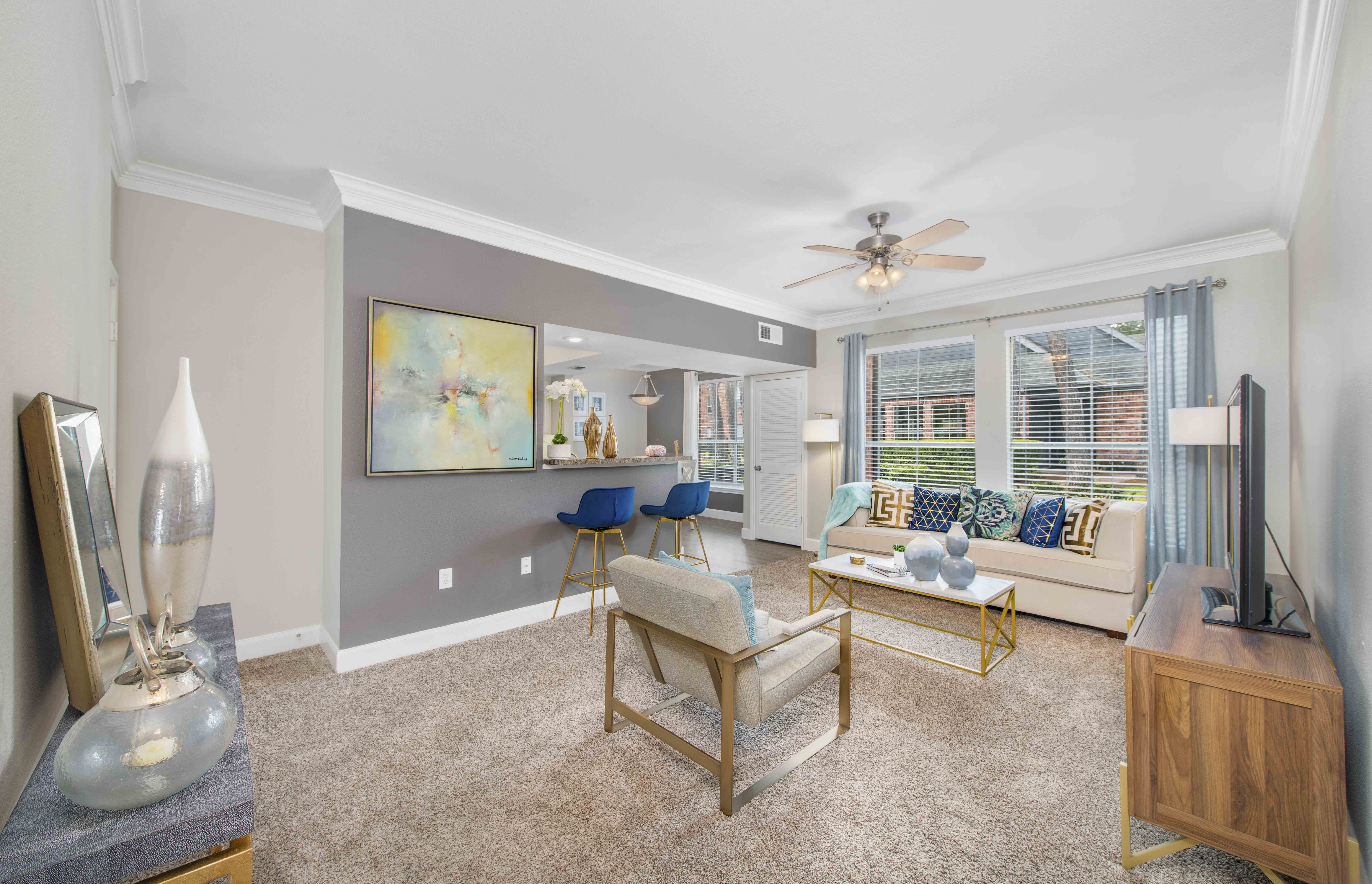 a living room with a couch and a ceiling fan