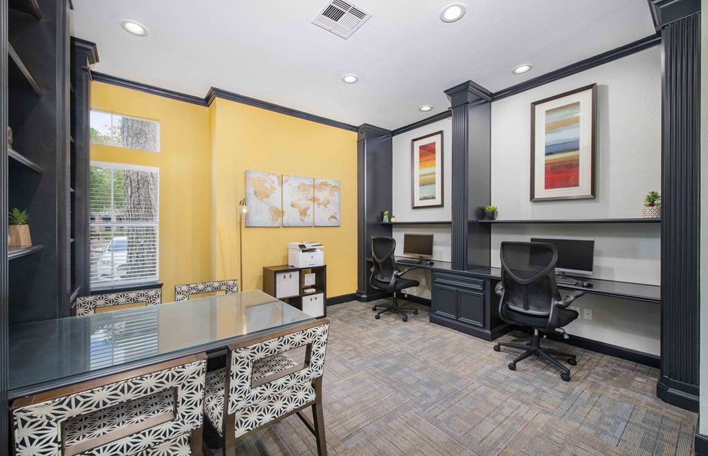 A conference room with a long table and chairs.