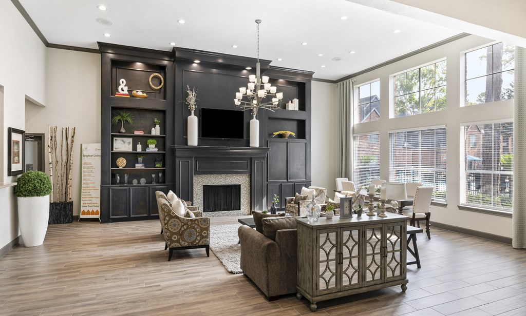 A modern living room with a fireplace and a large sofa.