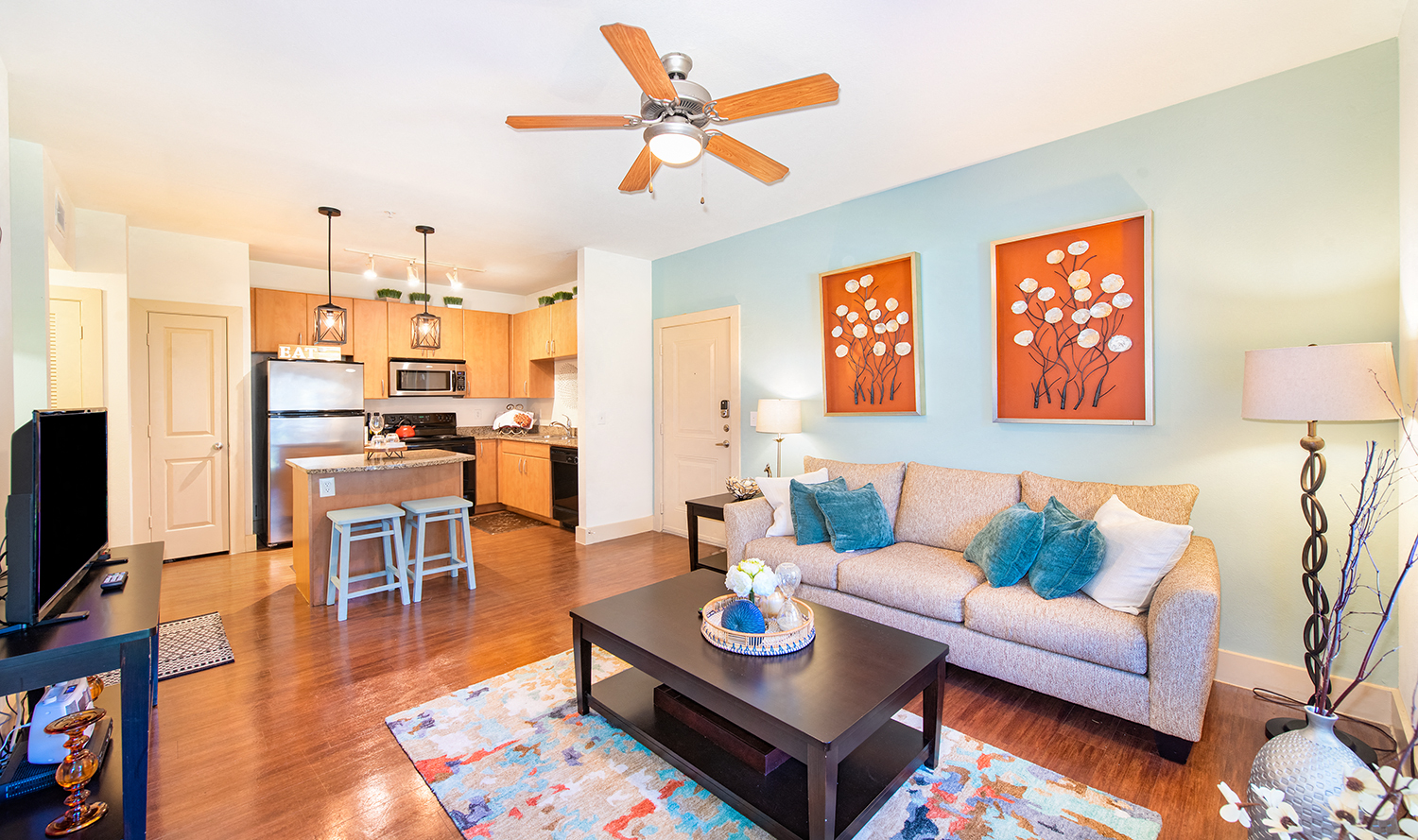 a living room with a couch and a ceiling fan