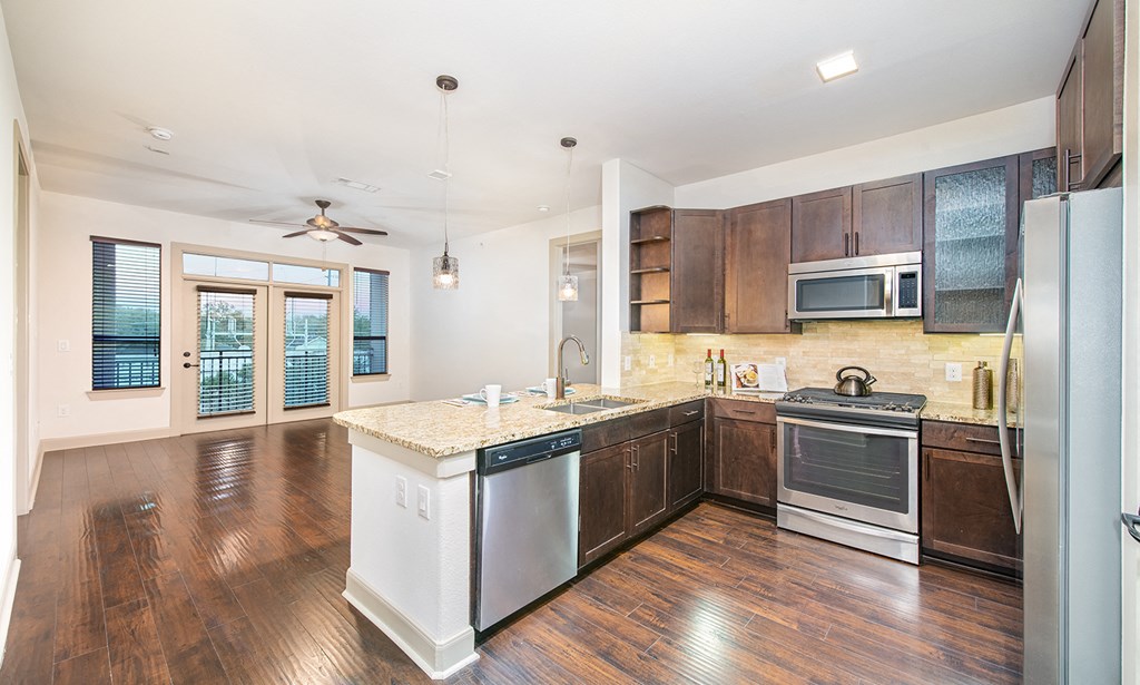 a kitchen with an island and stainless steel appliances