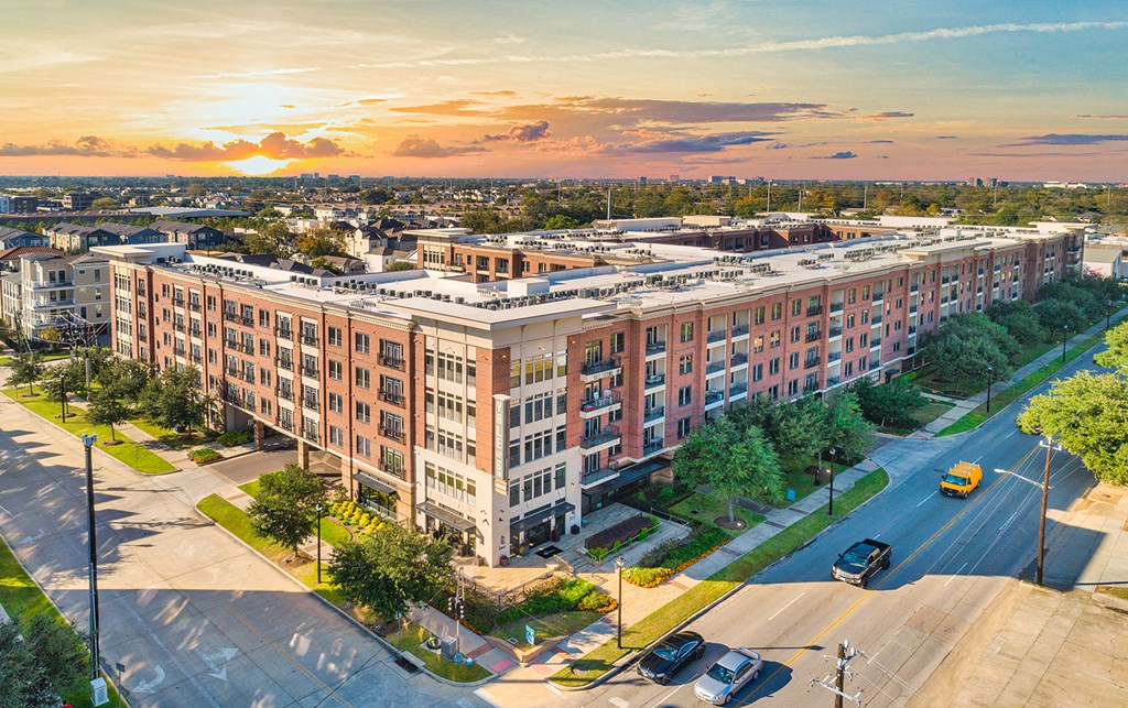 an aerial view of a large apartment building on a city street