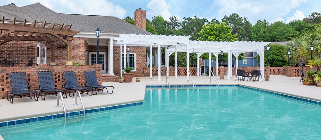 the pool and patio area of a house with a resort style pool