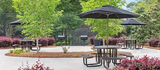 an outdoor patio with tables and umbrellas