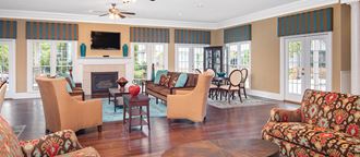a living room with a table and chairs and a fireplace