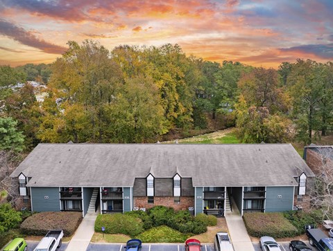 A building with a parking lot in front of it.