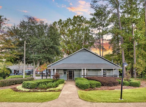 A house with a grey roof and a green lawn in front.