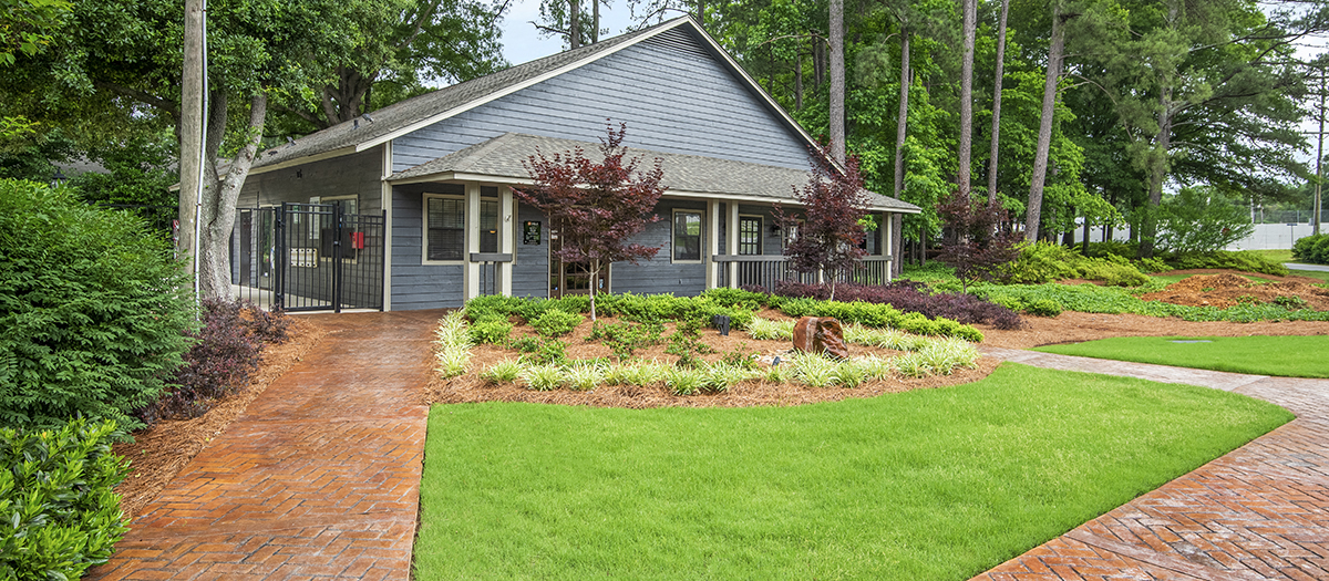 a house with a garden and a walkway in front of it