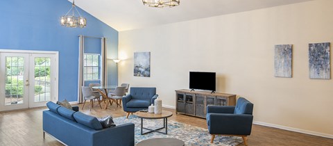 a living room with blue furniture and a tv