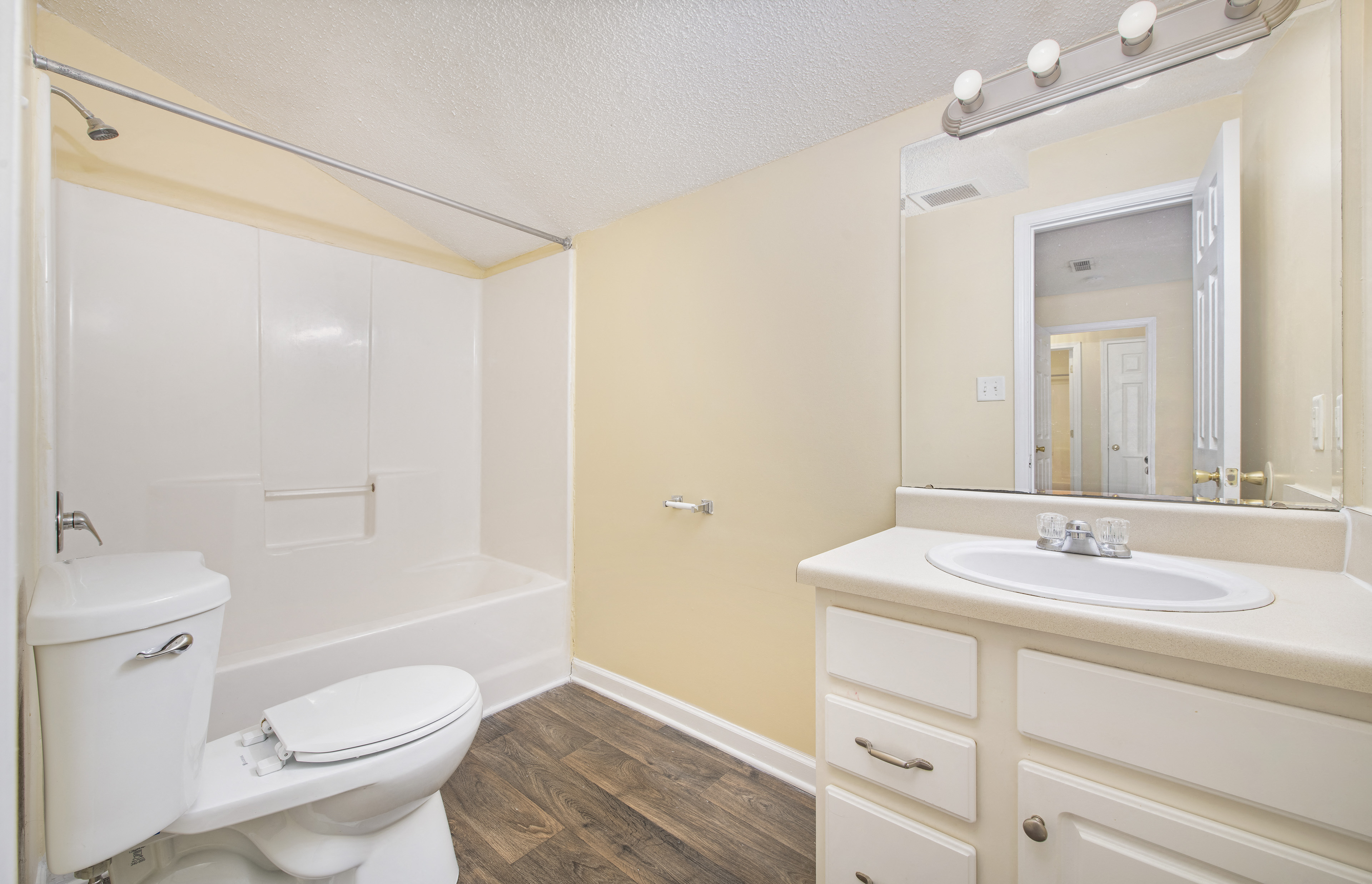 a bathroom with a toilet sink and a mirror