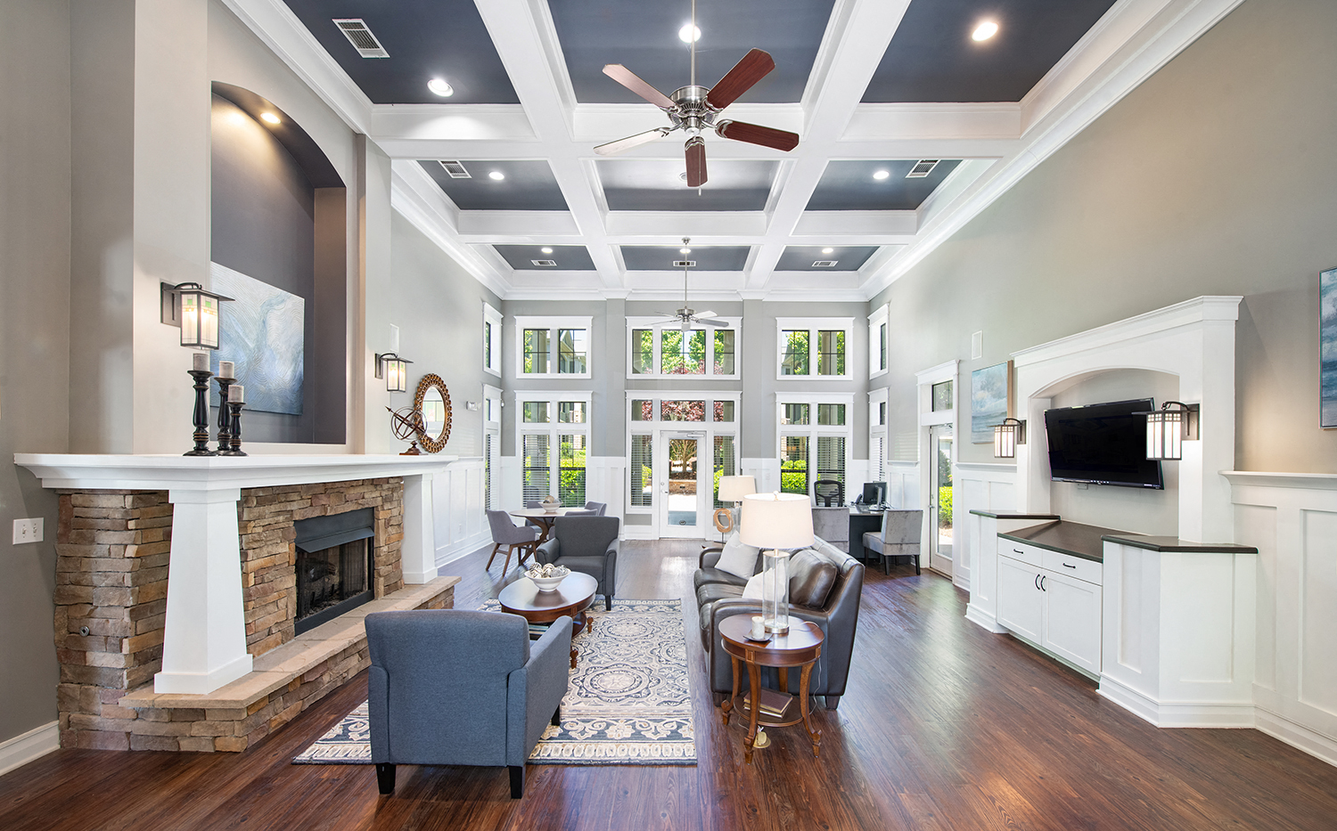 a living room with a fireplace and a ceiling fan
