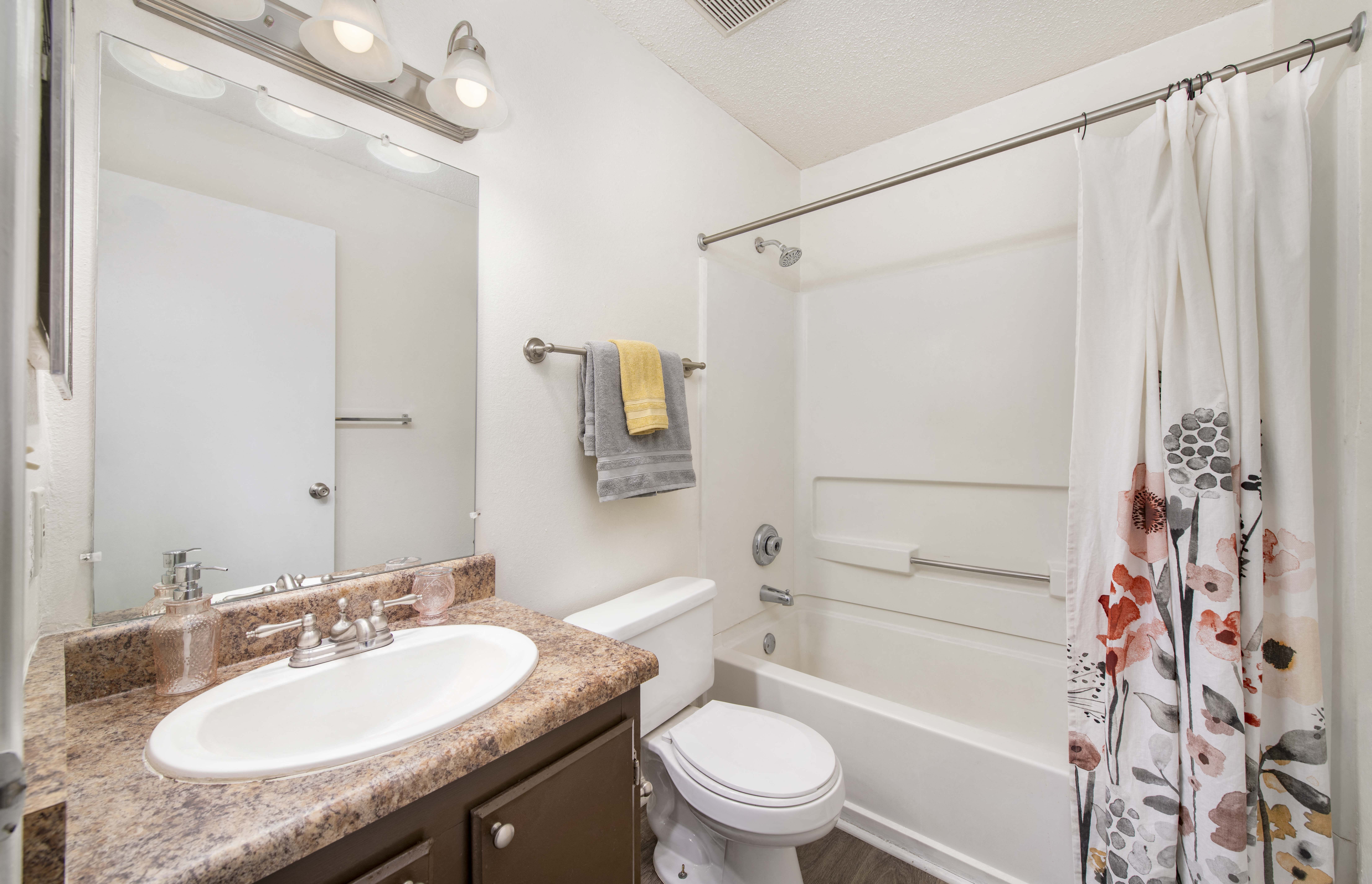 a bathroom with a sink toilet and shower