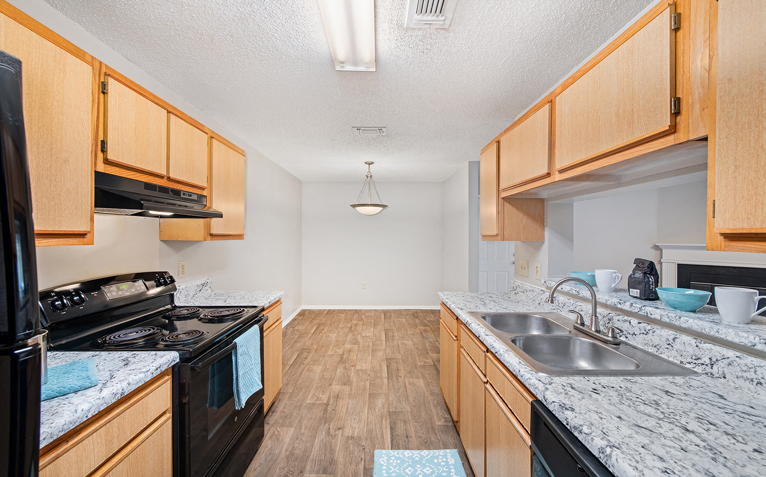 a kitchen with granite counter tops and wooden cabinets