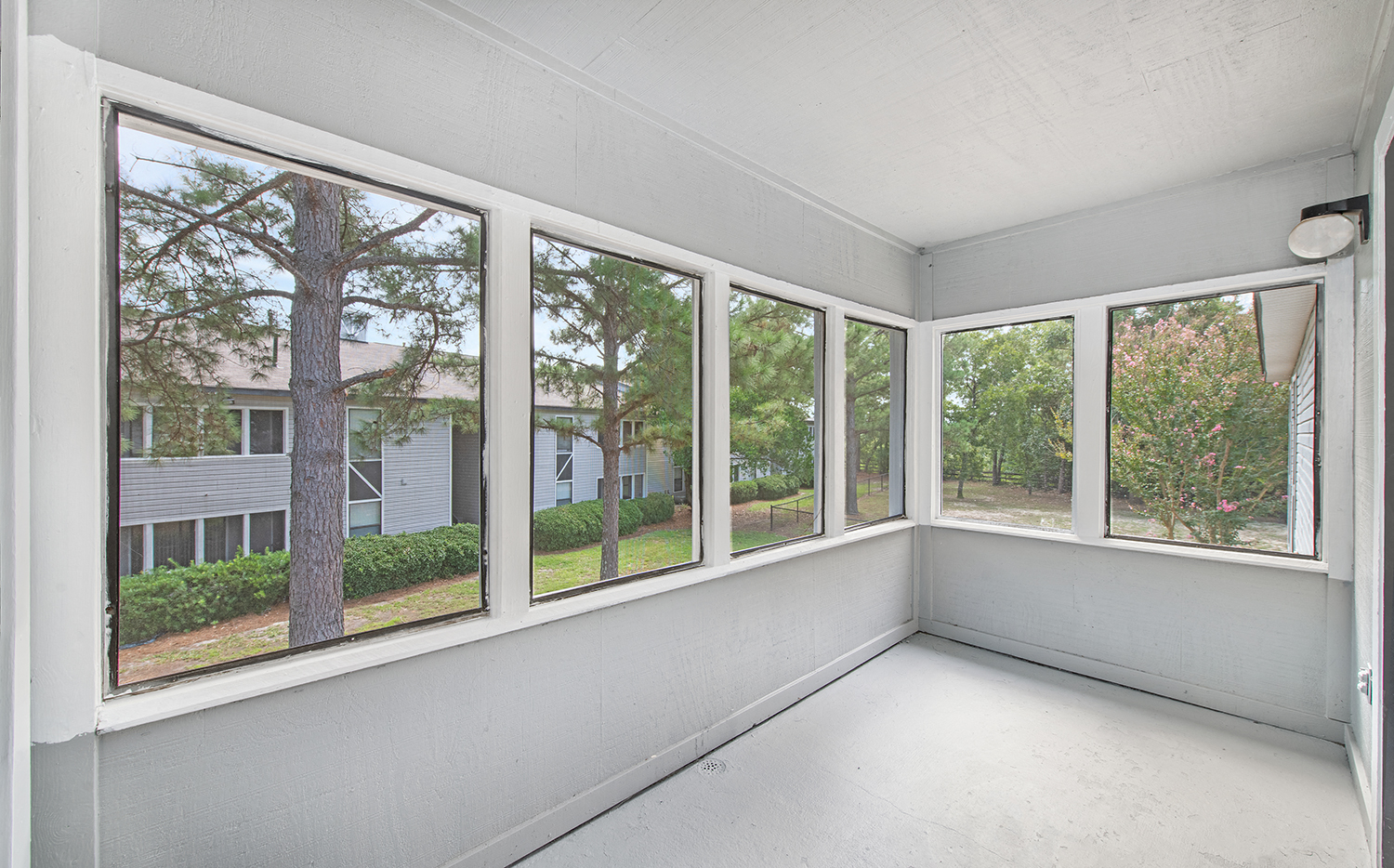 a room with a bunch of windows and a white floor