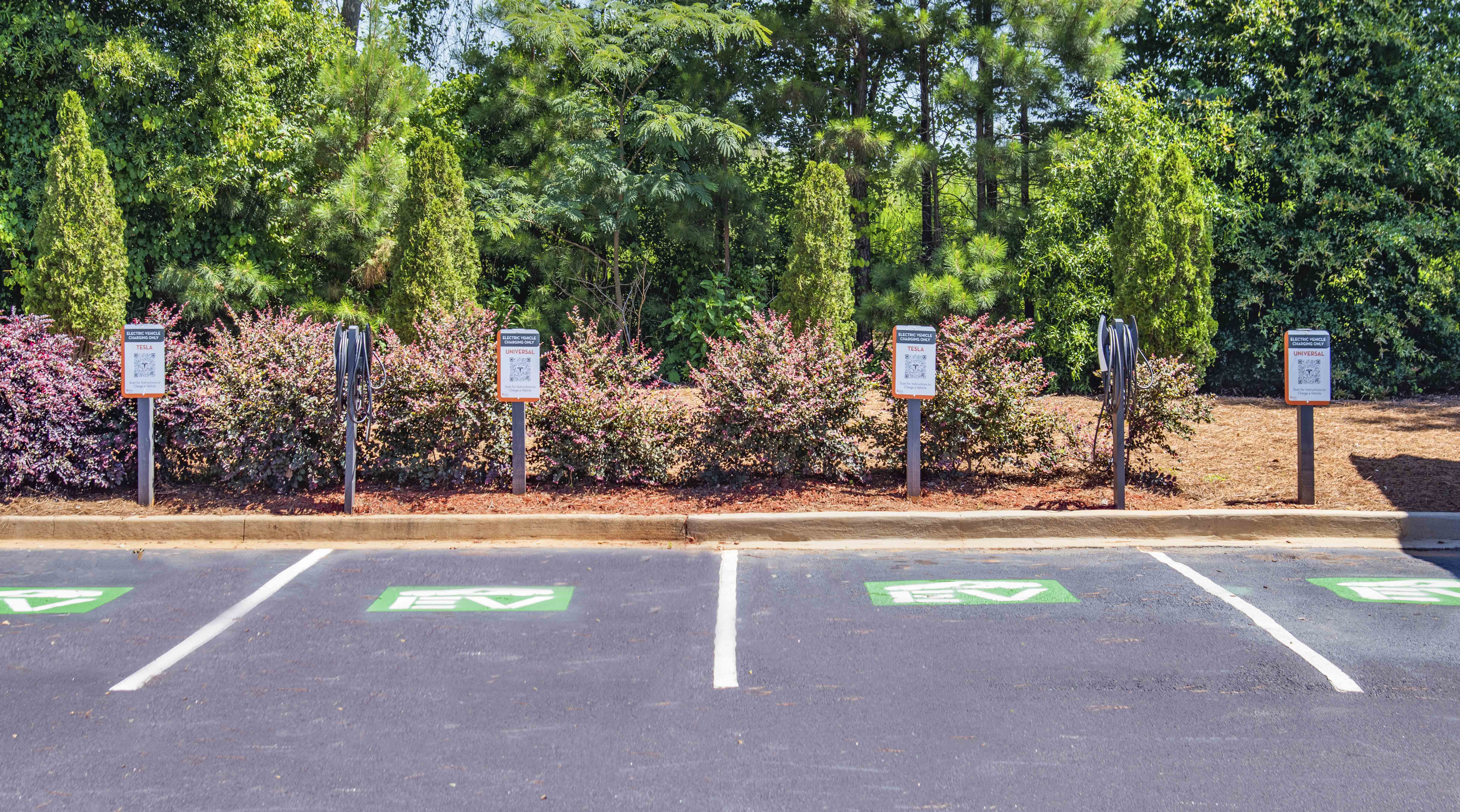 a parking lot with signs in front of a park