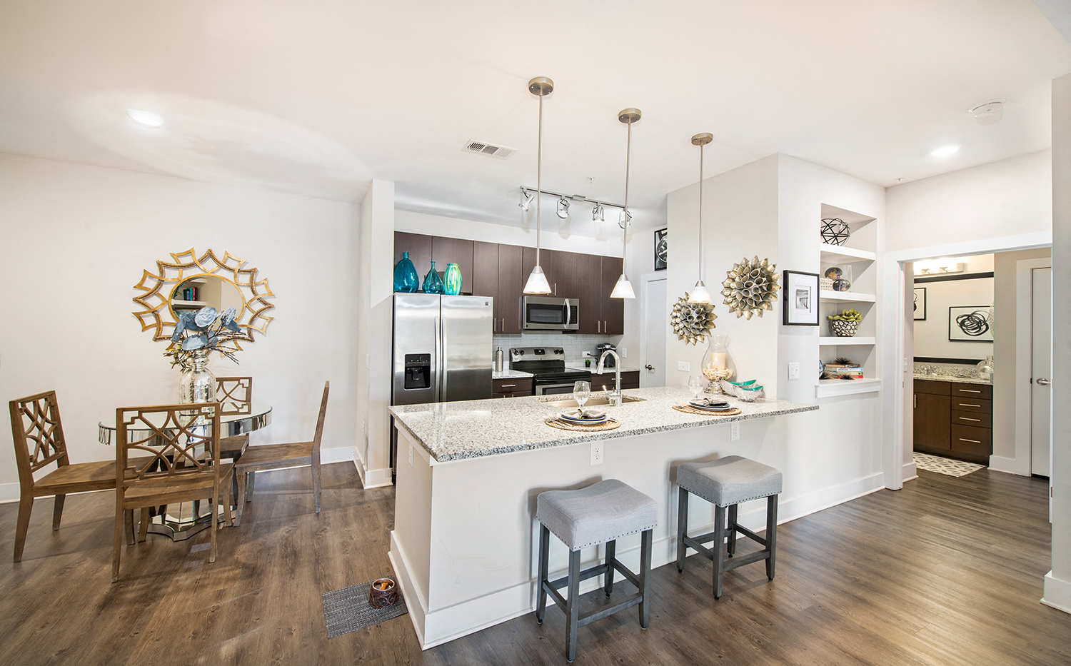 a kitchen with an island and a dining room