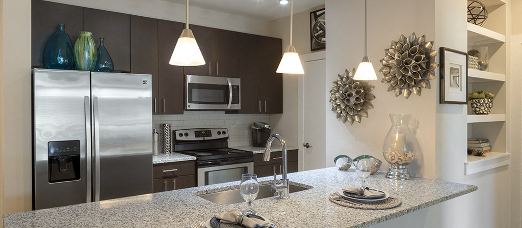 a kitchen with stainless steel appliances and granite counter tops