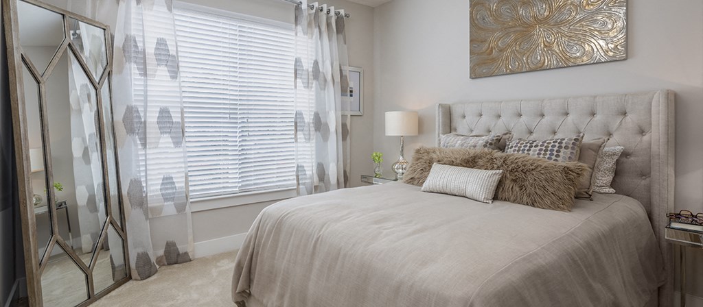 a bedroom with a large bed and a window