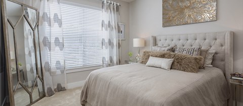 a bedroom with a large bed and a window