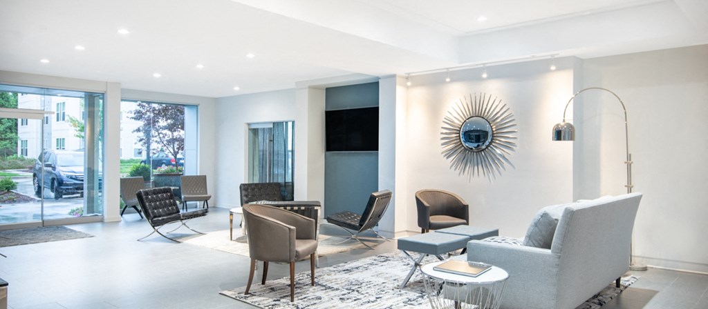 a living room with a couch and chairs and a tv