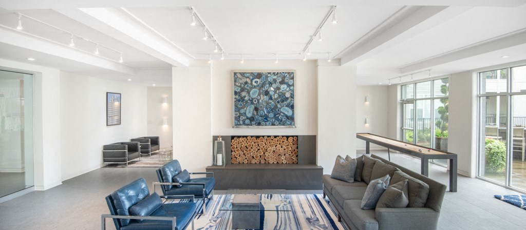 a living room with a couch and chairs and a fireplace