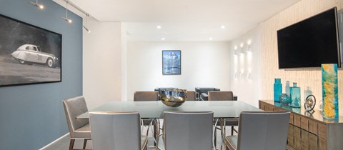 a dining room with a glass table and chairs