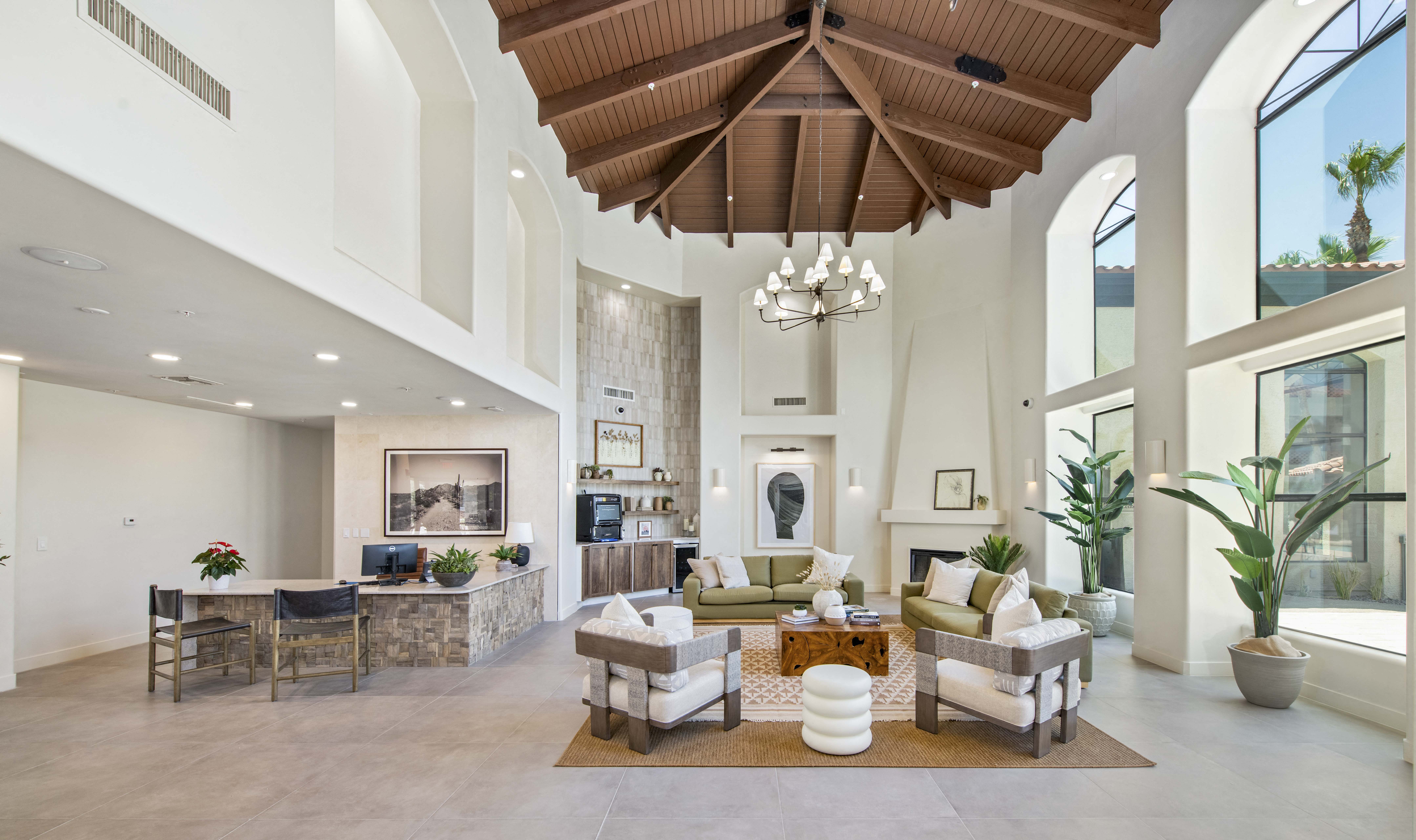a large living room with high ceilings and a fireplace