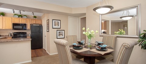 a dining room and kitchen with a table and chairs