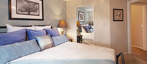 a bedroom with a bed and a door to a bathroom