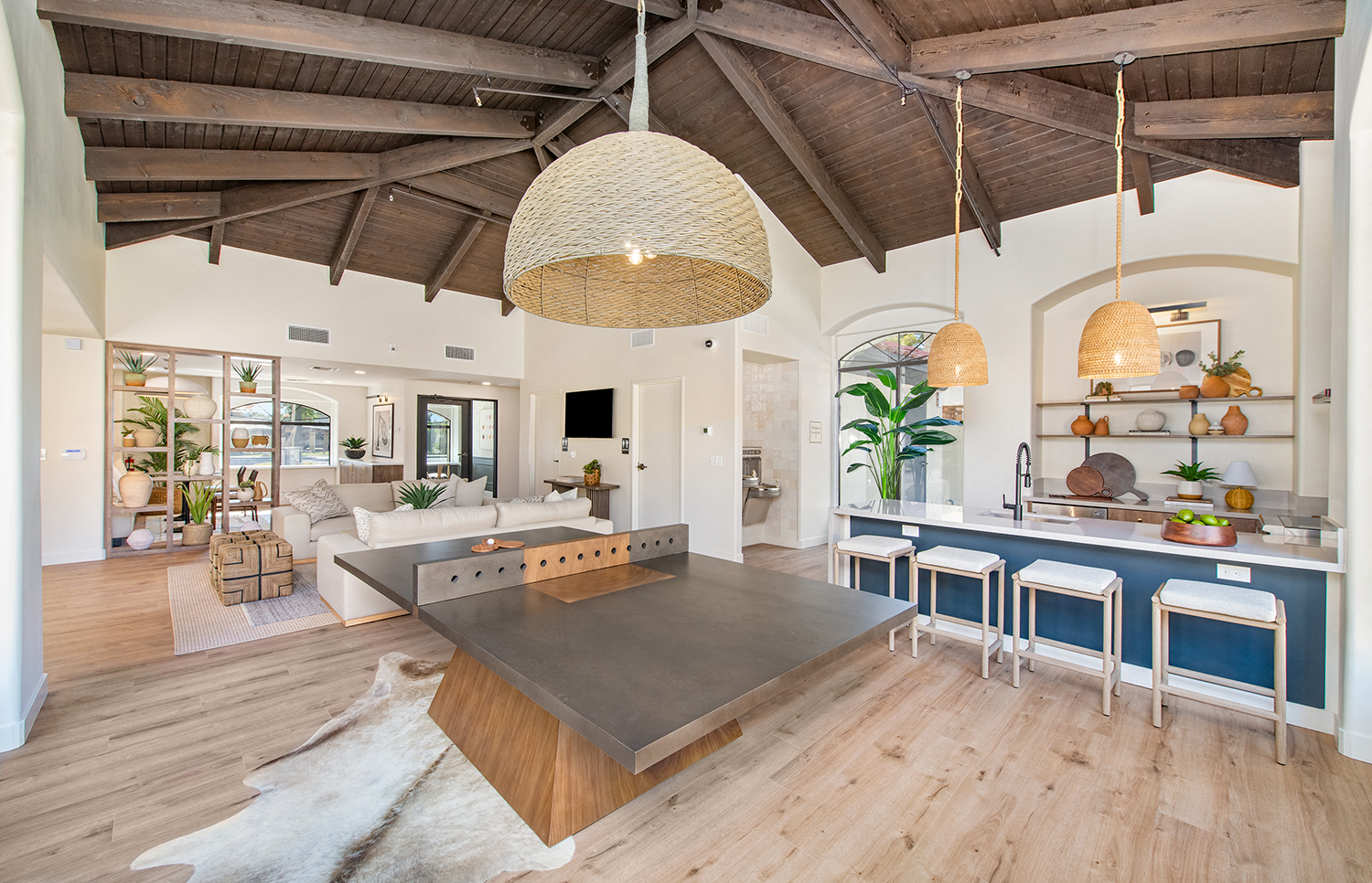 a large living room with a dining room table and a kitchen