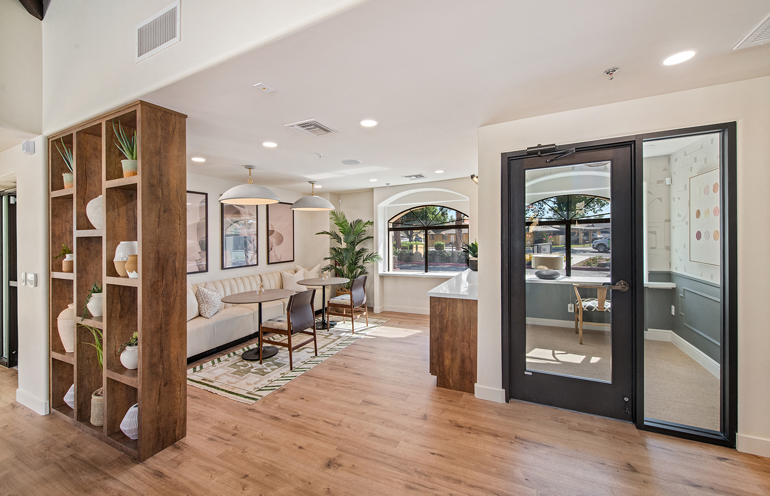 a living room and dining room with a door to a kitchen
