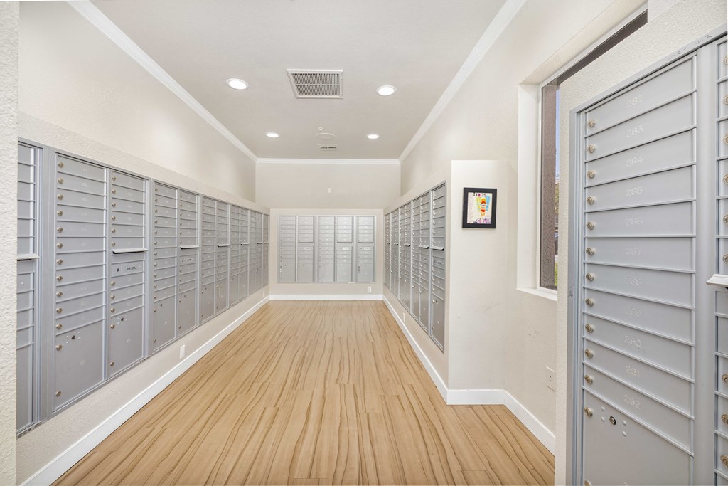 a lockers room in a basement with wood flooring and doors