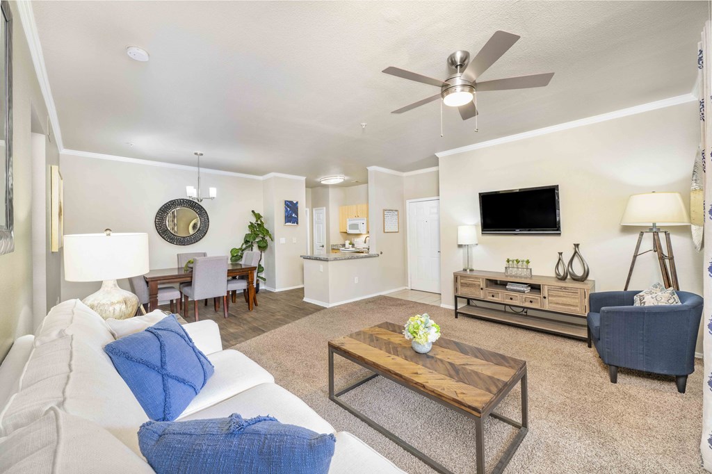 a living room with furniture and a ceiling fan
