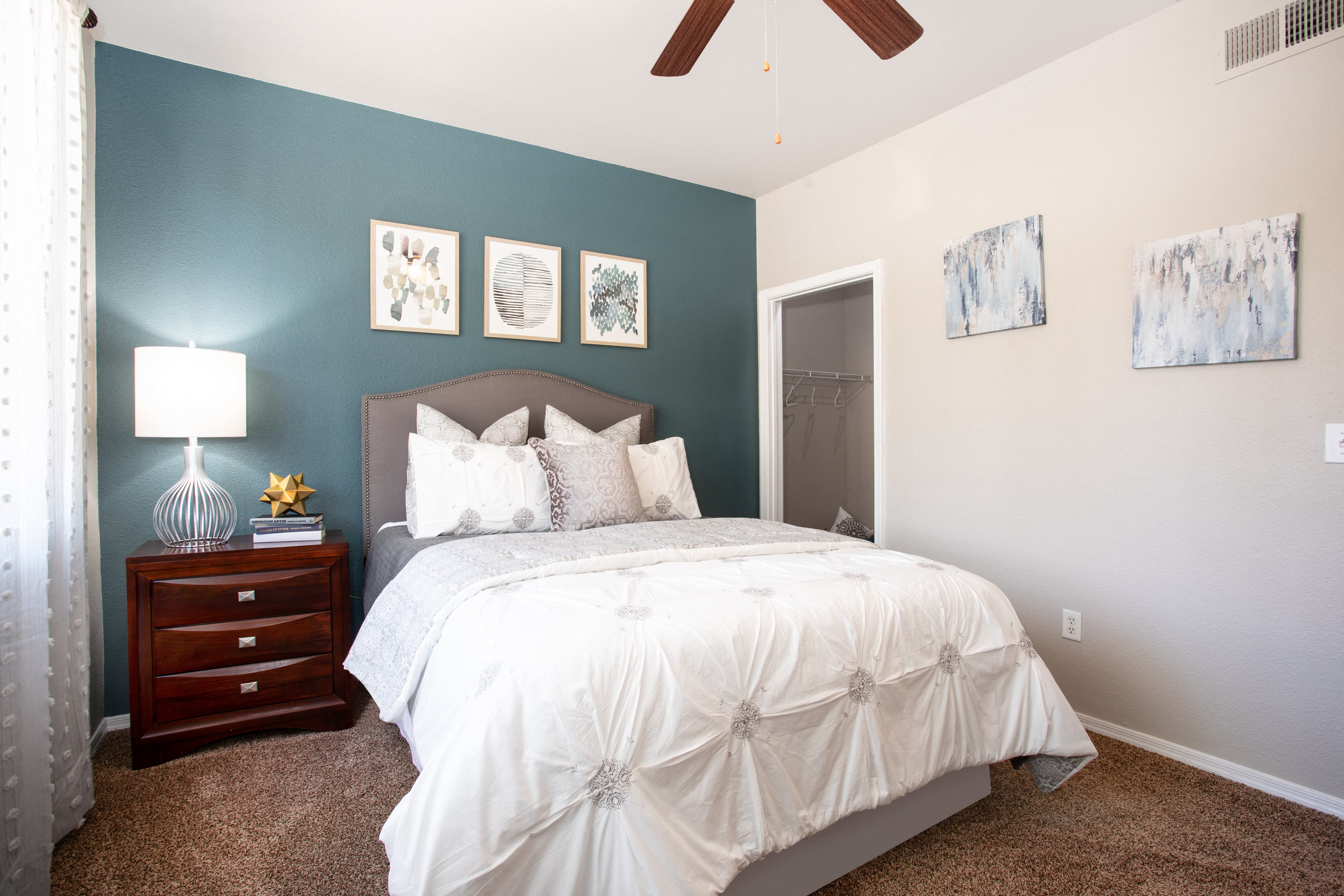 a bedroom with blue and white walls and a bed