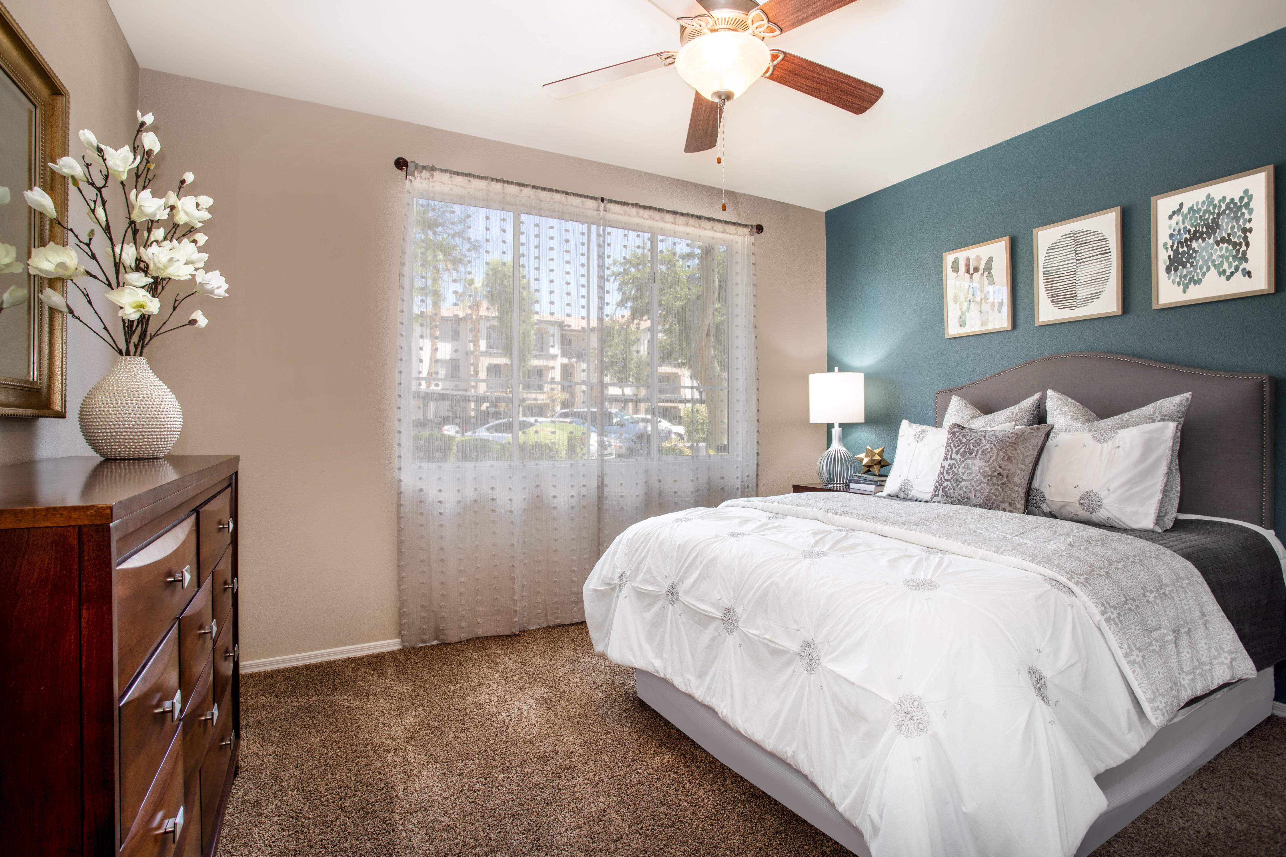 a bedroom with a large bed and a ceiling fan