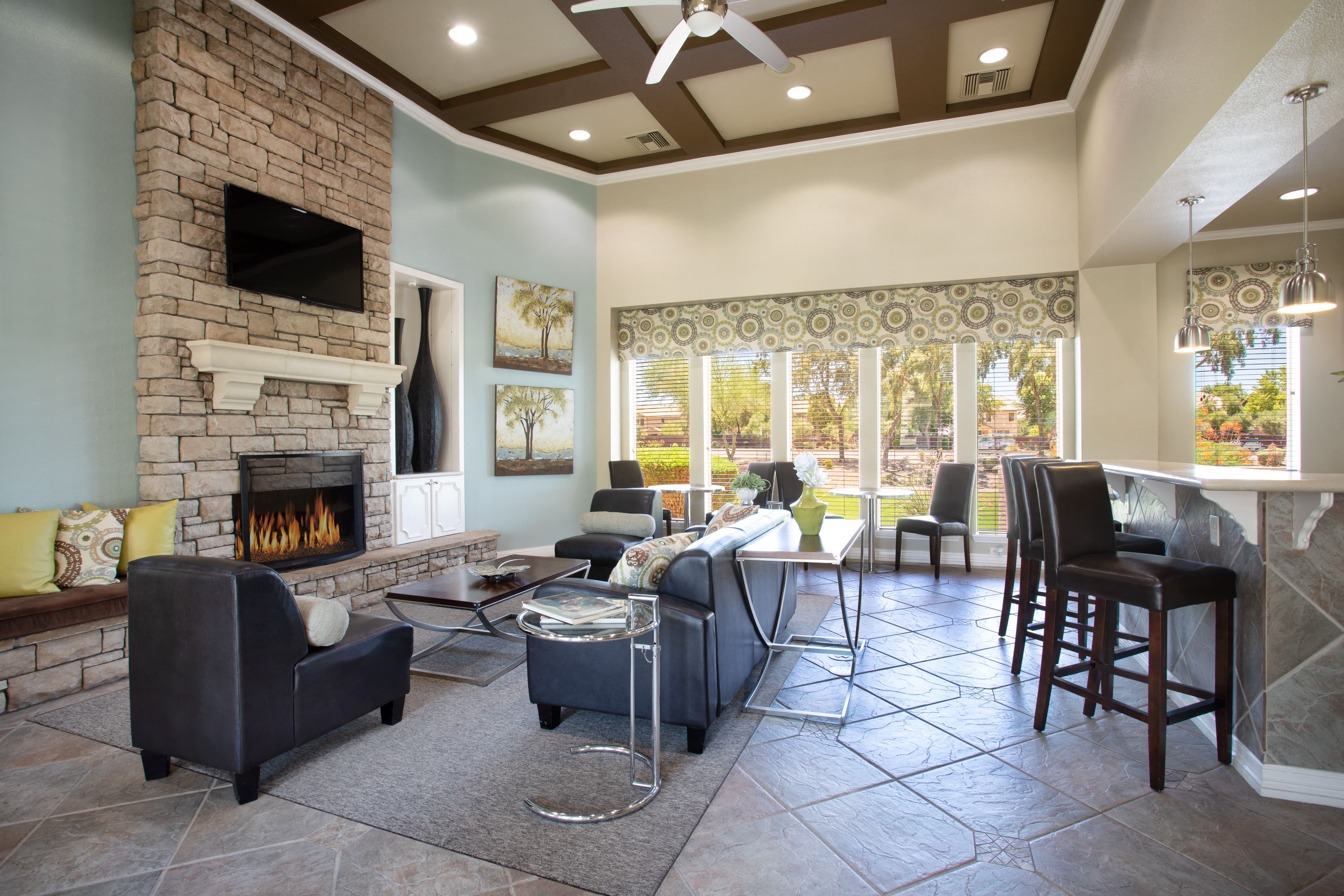 a living room with a fireplace and a table with chairs